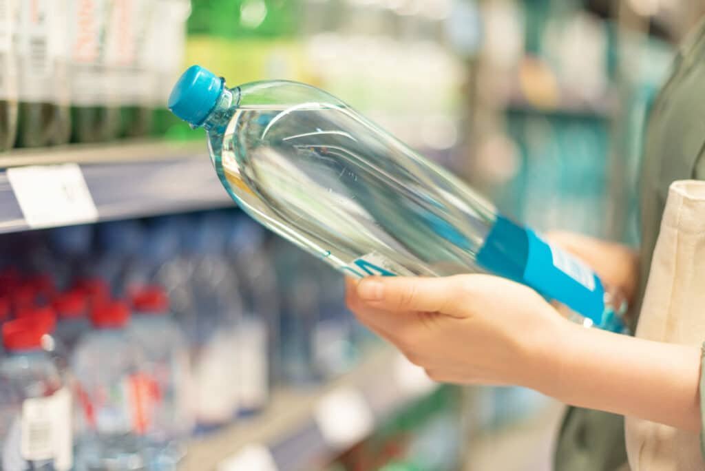 ragazza che sceglie una bottiglia di acqua potabile al supermercato 2021 08 26 20 11 39 utc(1)(1)